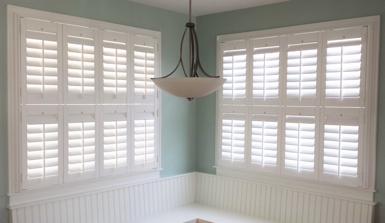 Pastel green wall in Dallas kitchen with shutters.